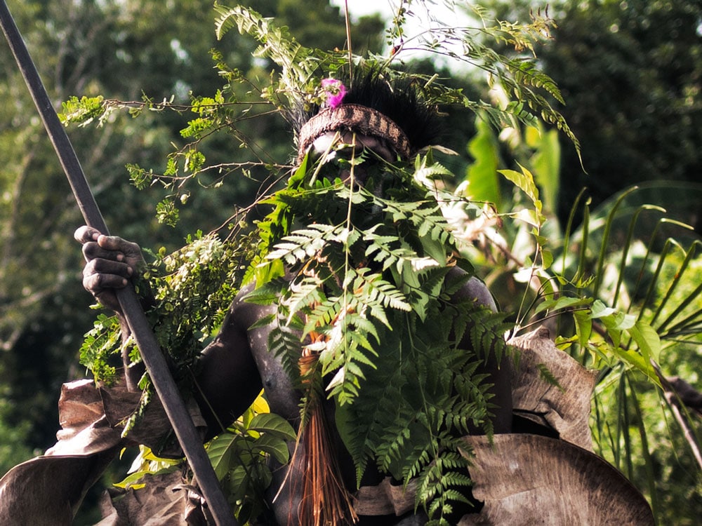 Asmat tribe man in camouflage costume