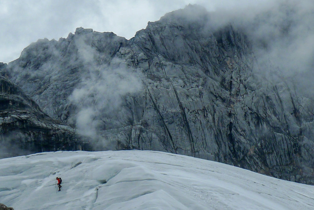 ice glacier with mountain climber and clouds